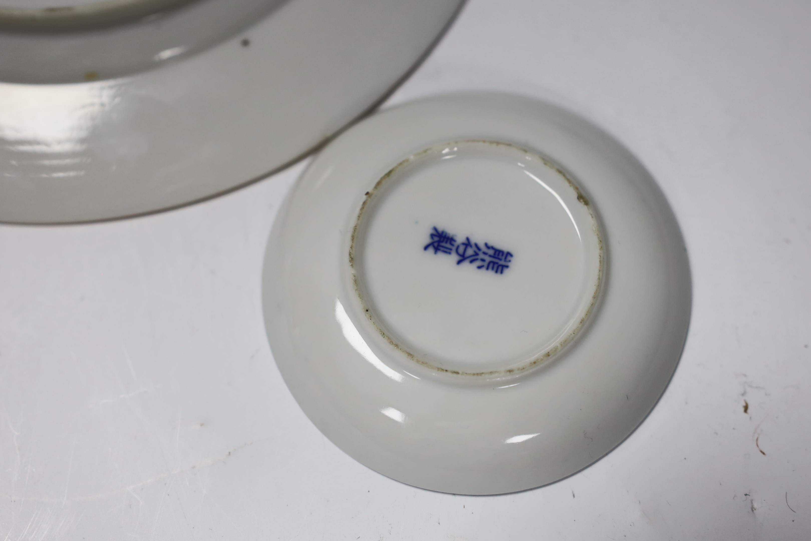 A group of 18th century Chinese porcelain plates and saucers, mostly blue and white and an octagonal famille rose example, together with three Japanese dishes, largest 27cm in diameter